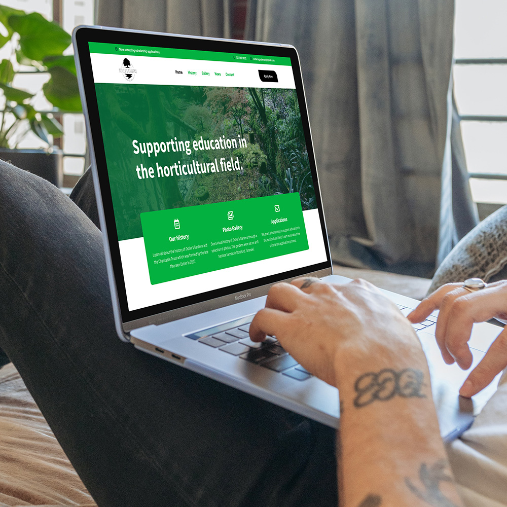 Taranaki Media laptop showing our web design services with the Ostler's Gardens website